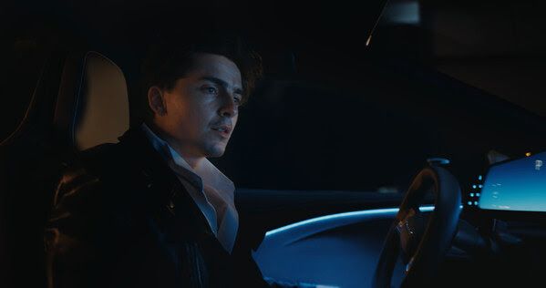 The Groom, portrayed by Timothée Chalamet, sits inside the cockpit of Lucid Gravity in Lucid’s latest creative campaign, “Driven.” 
